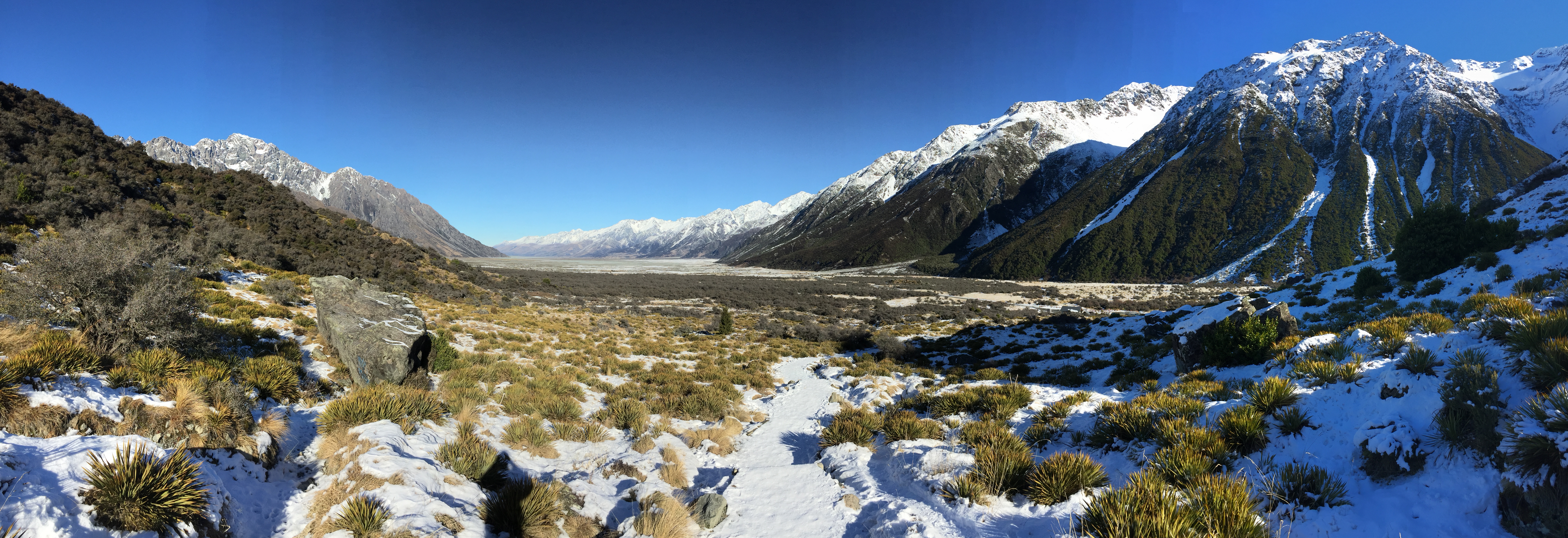 A snow-covered hiking trail through the mountains