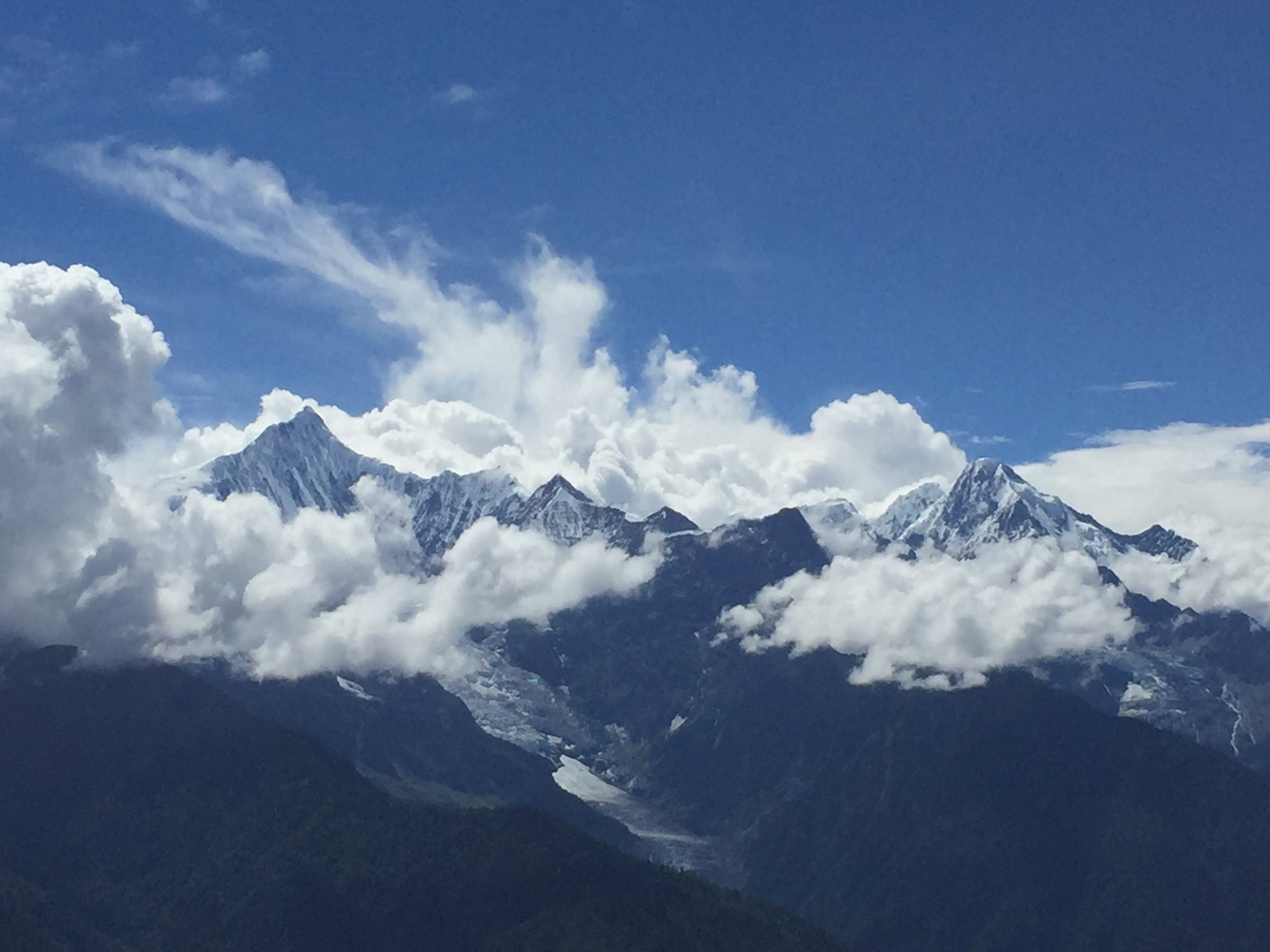 A range of snowy peaks beneath a blue sky