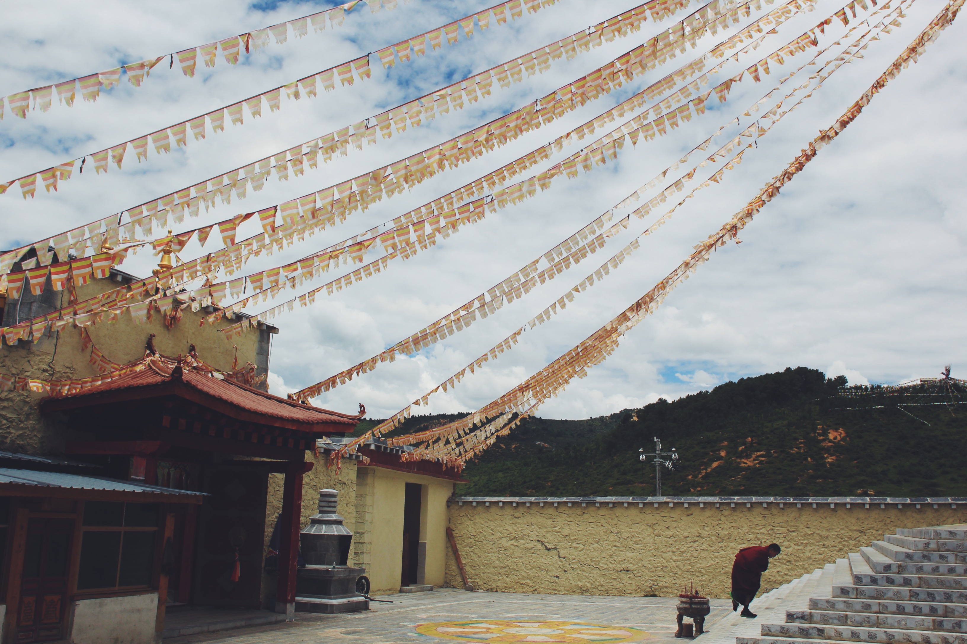 A temple square beneath rows of prayer flags