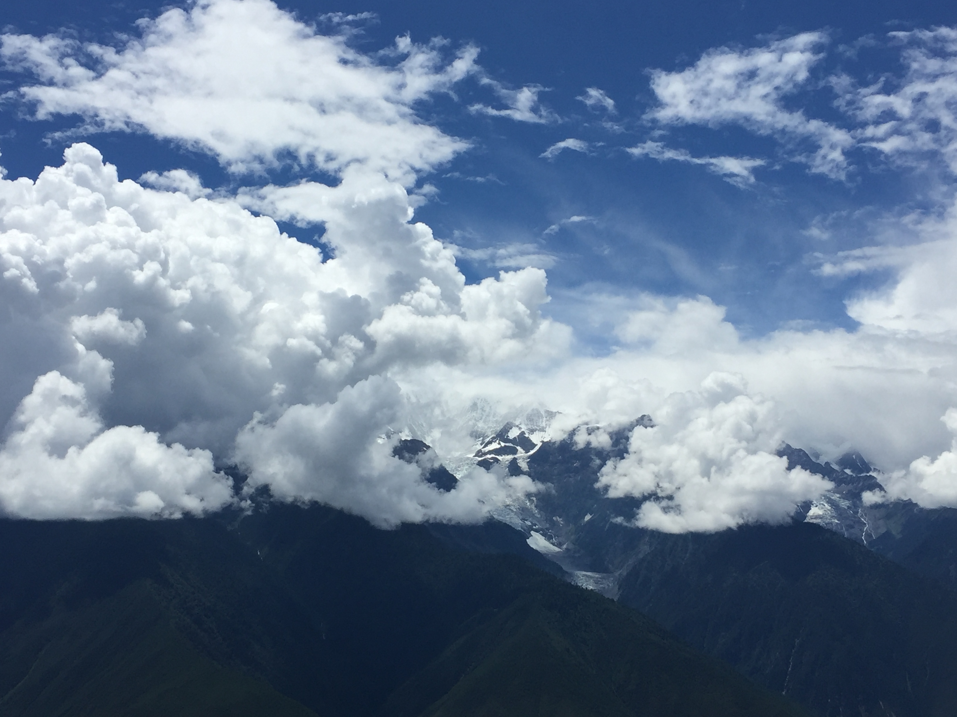 Snow-capped mountains surrounded by clouds