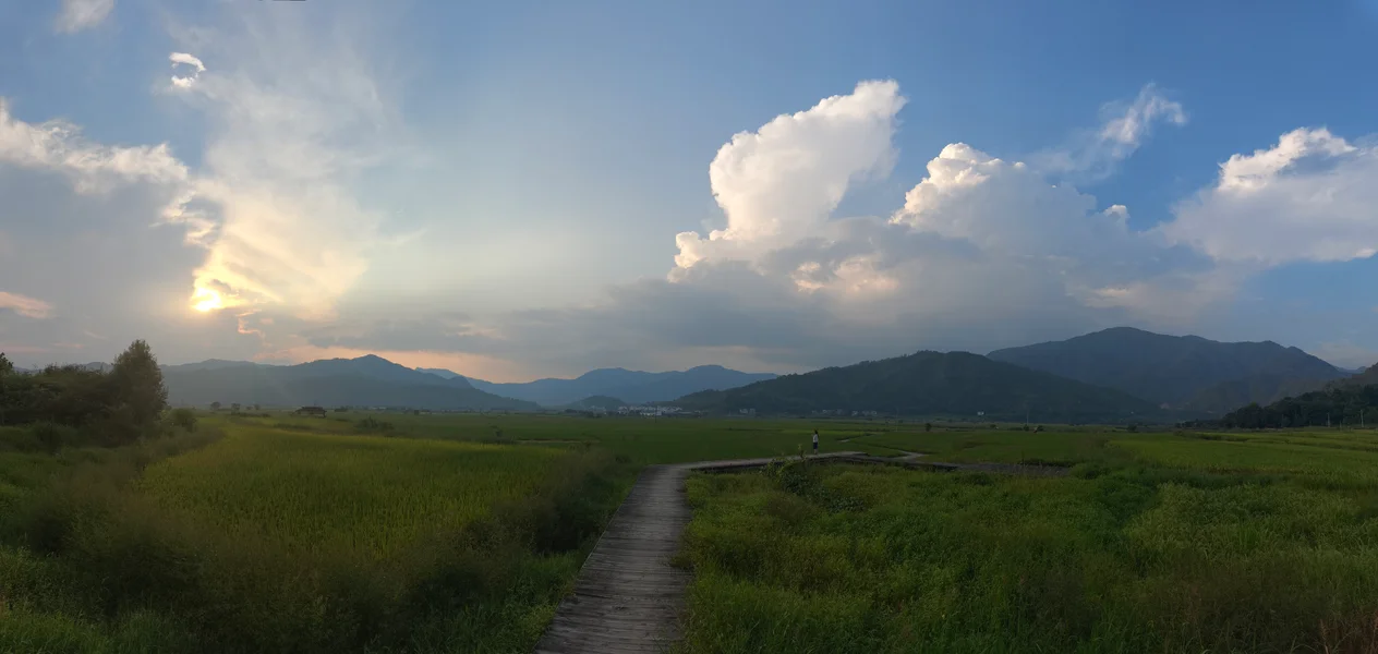 云层下通往群山的乡间小路